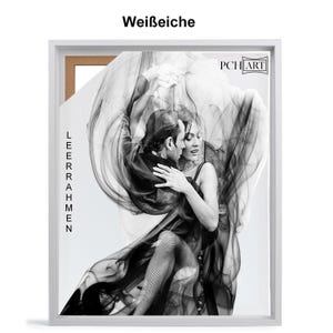 May include: A black and white photograph of a couple dancing. The woman is wearing a long, flowing dress and the man is wearing a suit. The image is framed in a white frame with the text "LEERAHMEN" and "PCH ART" printed on it.