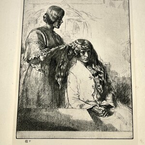 May include: Black and white etching of two women. One woman is seated, with long, flowing hair, while another stands behind her, appearing to braid her hair. The artwork is detailed, with visible lines and shading, creating a vintage aesthetic.