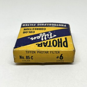 May include: A yellow and blue box for a Tiffen Photar filter, labelled "No. 85-C Colour" and "#6 Series".