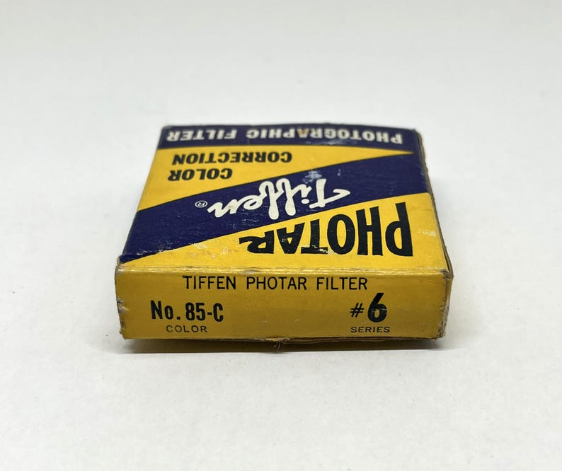 May include: A yellow and blue box for a Tiffen Photar filter, labelled "No. 85-C Colour" and "#6 Series".