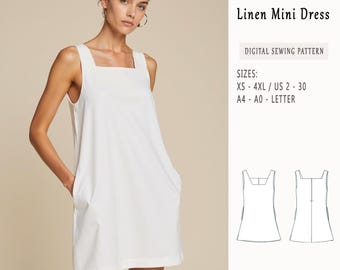 May include: A white linen mini dress sewing pattern. The pattern includes sizes XS-4XL, US 2-30, and A4-A0 letter sizes. The pattern is shown on a white dress with pockets.