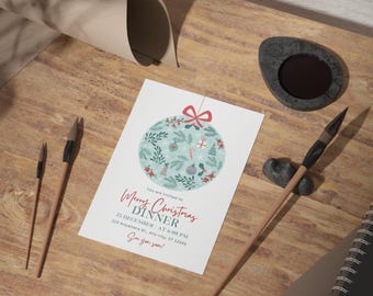May include: A white Christmas dinner invitation with a green and red ornament illustration. The invitation reads "You are invited to Merry Christmas Dinner 25 December at 6:00 PM 123 Anywhere St, Any city, ST 12345 See you soon!"