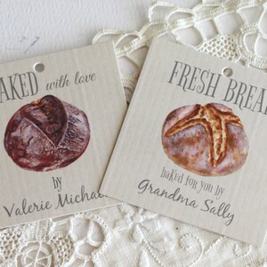 May include: Two brown paper gift tags with images of bread and the text "BAKED with love by Valerie Micha" and "FRESH BREAD baked for you by Grandma Sally".