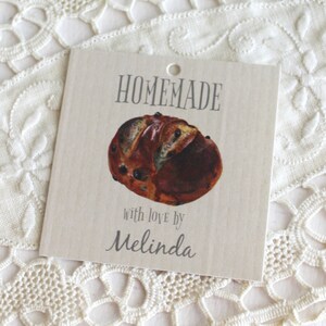 May include: A brown and white homemade bread with a tag that says "HOMEMADE with love by Melinda".