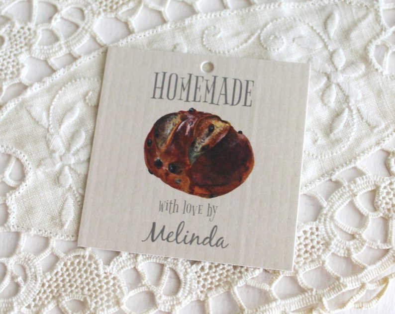 May include: A brown and white homemade bread with a tag that says "HOMEMADE with love by Melinda".