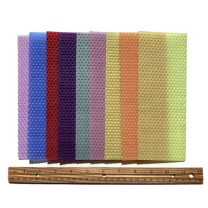 1 pound, 30 pieces, of Assorted beeswax scrap pieces. Each scrap sheet measures between 2 - 3 inches wide by 8 inches long.