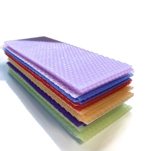 1 pound, 30 pieces, of Assorted beeswax scrap pieces. Each scrap sheet measures between 2 - 3 inches wide by 8 inches long.