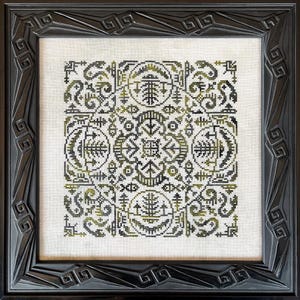 May include: A framed cross-stitch artwork featuring a symmetrical design in black and olive green. The intricate pattern includes geometric shapes, circles, and stylized plant-like motifs. The artwork is set within a black, ornate wooden frame.