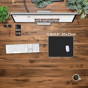 May include: A top-down view of a wooden desk with a computer monitor, keyboard, and mouse. A black mousepad, measuring 11.8 x 9.8 inches (30 x 25 cm), is in the center. Other items include a smartphone, sunglasses, and a cup of coffee.