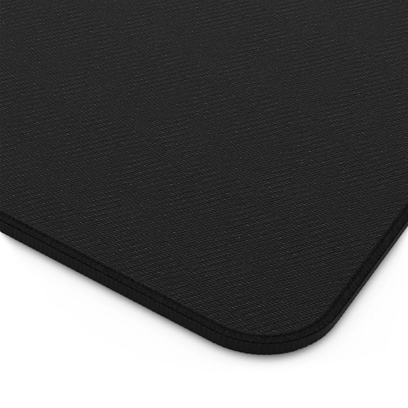 May include: A black rectangular desk mat with a textured surface. The mat has rounded corners and a stitched edge. The mat is made of a durable material and is designed for use with a computer mouse.