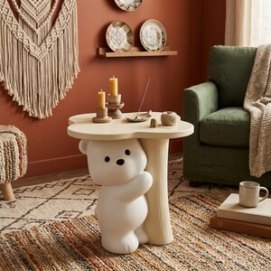 May include: A whimsical, cream-colored side table with a bear-shaped base. The table has a flower-shaped top and is decorated with candles and other small items. The table is placed on a patterned rug in a cozy living room setting.