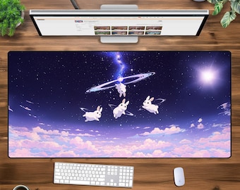 May include: A purple and blue galaxy-themed mousepad with white bunnies flying through the clouds. The mousepad has a starry night sky background with a galaxy of stars and a ring of planets.