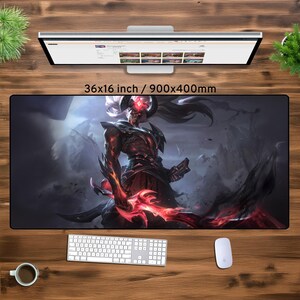 May include: A black and red gaming mouse mat featuring a fantasy character with horns and a red sword. The mouse mat is 36x16 inches or 900x400mm.