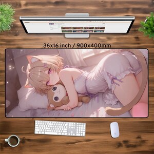 May include: A large mouse mat featuring a colourful anime illustration of a girl with cat ears and a tail, holding a plush toy. The background is a soft pink and white with a hint of sparkle. The mouse mat measures 36x16 inches or 900x400 millimetres.