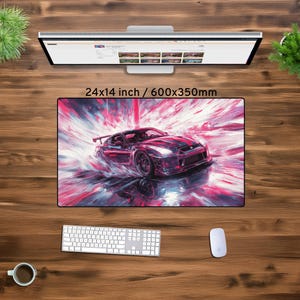May include: A red and black sports car with a white stripe on the hood is driving through a colorful, abstract background. The car is surrounded by a burst of pink, blue, and white paint splatters. The image is 24x14 inches or 600x350mm.