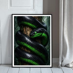 May include: A framed art print featuring a black and green snake coiled around a tree trunk. The snake has green eyes and a detailed scale pattern. The artwork is set against a blurred forest background.