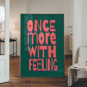 May include: A teal green poster with the text "ONCE more WITH FEELING" in pink letters.