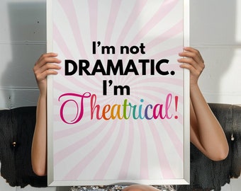 May include: A white framed print with a pink background and a rainbow colored text that reads "I'm not DRAMATIC. I'm Theatrical!"