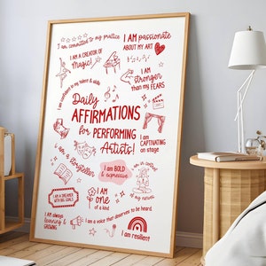 May include: A white dry-erase board with red handwritten text and illustrations. The text includes affirmations for performing artists, such as "I am a creator of magic", "I am stronger than my fears", and "I am a voice that deserves to be heard".