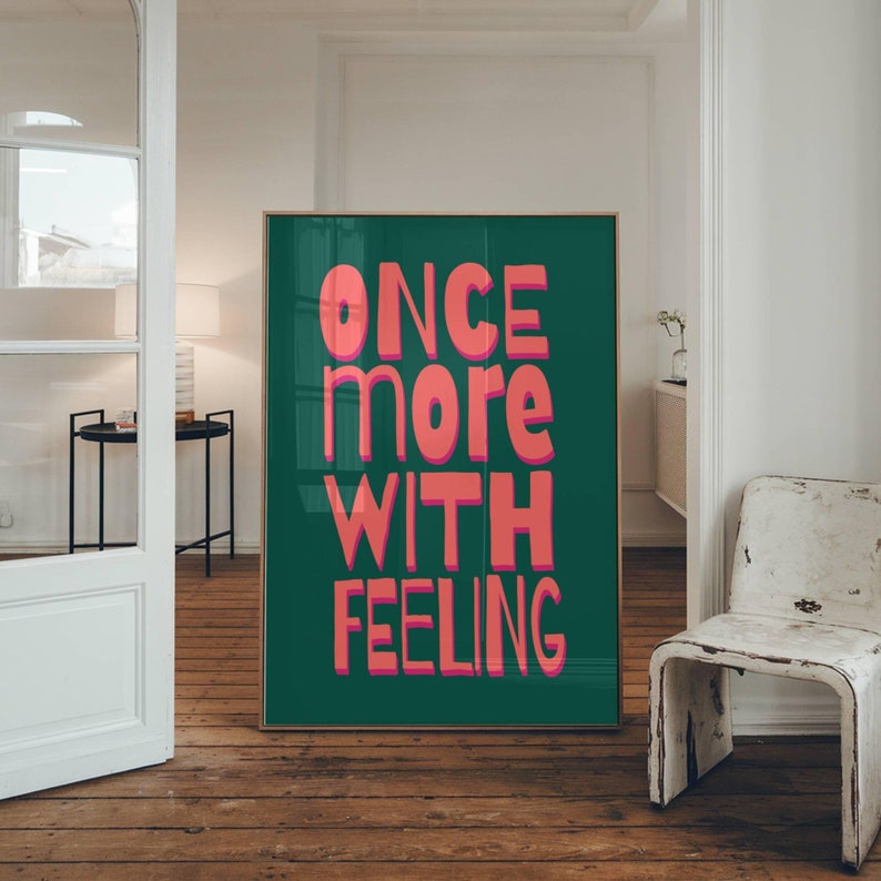 May include: A teal green poster with the text "ONCE more WITH FEELING" in pink letters.