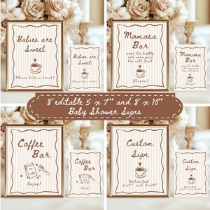 May include: A collection of baby shower signs in various sizes, featuring phrases like "Babies are Sweet" and "Momosa Bar." The signs have a vintage design with a coffee cup illustration and decorative borders. The signs are in gold frames.