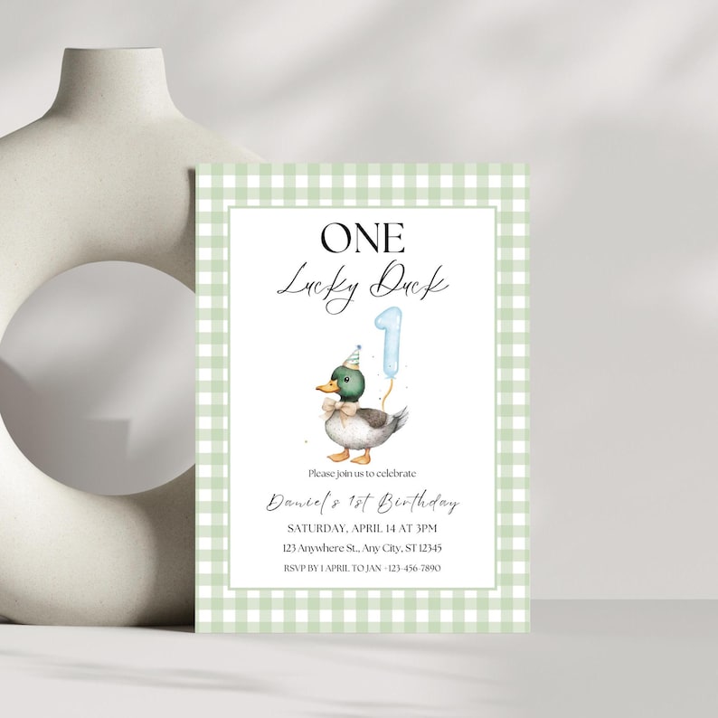 May include: Green and white gingham patterned invitation with a cartoon duck wearing a party hat and holding a blue number one balloon. The text reads "ONE Lucky Duck" and "Daniel's 1st Birthday".