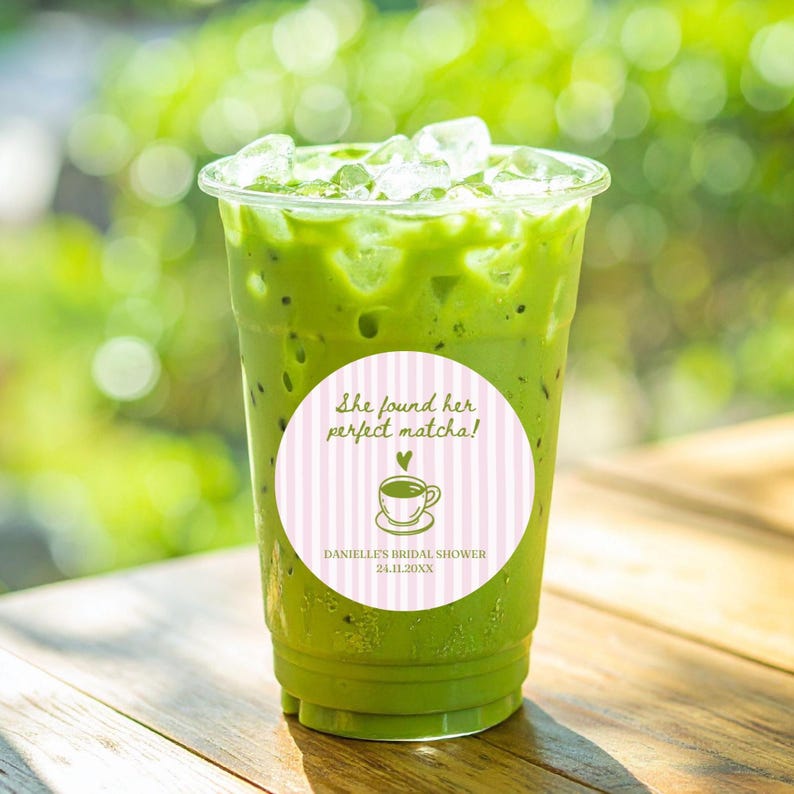 May include: A refreshing green matcha drink in a clear plastic cup filled with ice. A round sticker on the cup reads "She found her perfect matcha!" with a teacup illustration and "Danielle's Bridal Shower 24.11.20XX".
