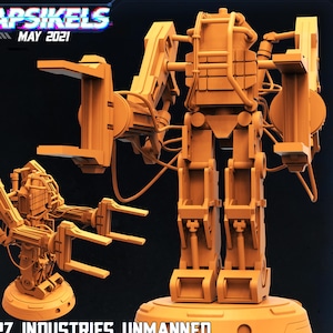 May include: An orange-colored 3D model of a loader-mode power suit, with the text "Papsikels May 2021" at the top and "Papz Industries Unmanned Power Suit - Loader Mode" at the bottom. The model has a detailed mechanical design.