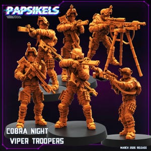 Puede incluir: Figuras de Cobra Night Viper Troopers de color naranja. Las figuras están en varias poses de acción, sosteniendo rifles y otros equipos. El texto "PAPSIKELS" está en la parte superior y "COBRA NIGHT VIPER TROOPERS" en la parte inferior. La fecha de lanzamiento es marzo de 2026.