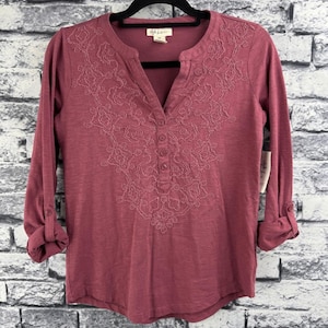 May include: A set of three ceramic mugs with a speckled, matte finish. The mugs are in shades of cream, light gray, and dark gray. Each mug has a simple, minimalist design, perfect for coffee or tea.