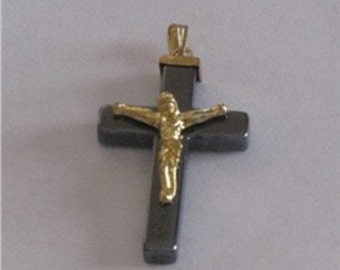 May include: A black and gold cross pendant with a Jesus figure. The cross is made of hematite and the Jesus figure is made of gold.
