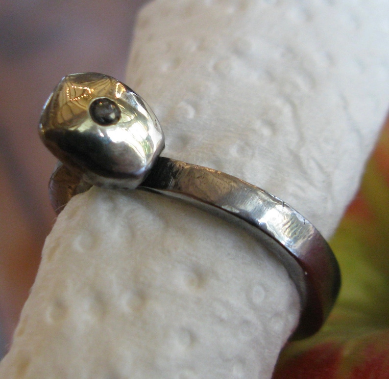 Old steel nail ring with gold capped head and solitaire diamond