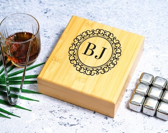 May include: A wooden box with a personalized engraved design featuring the initials "BJ" in a decorative circle. The box contains a set of stainless steel ice cubes.