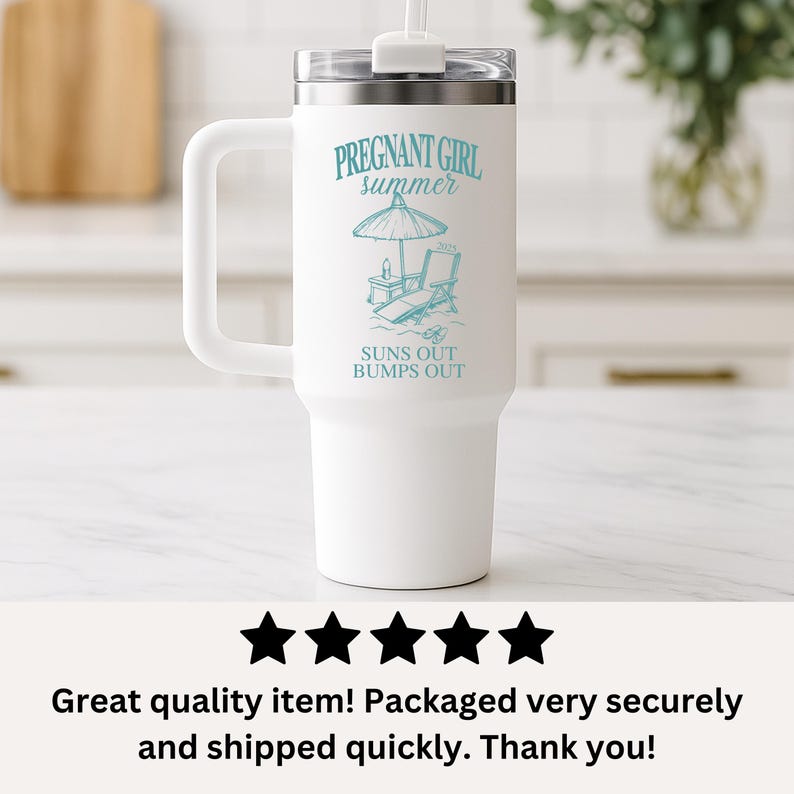 May include: White travel mug with a handle and a straw. The mug has a blue graphic of a beach umbrella, a lounge chair, and the text "PREGNANT GIRL summer SUNS OUT BUMPS OUT".
