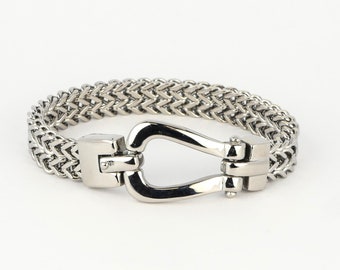 Elegant stainless steel bracelet with a polished finish & unique horseshoe closure, combining style and elegance for any occasion.