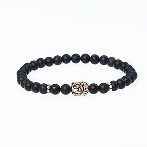 May include: Black beaded bracelet with a silver Buddha head charm.