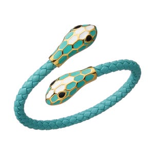 May include: A turquoise leather bracelet with two gold snake head accents. The snake heads are detailed with white and black enamel.