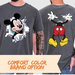 two men wearing t-shirts with Mickey Mouse designs.