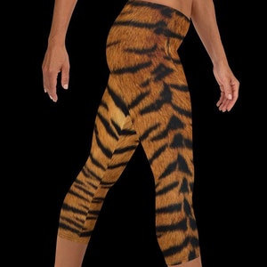May include: A pair of brown and orange tiger print leggings with a cropped length.