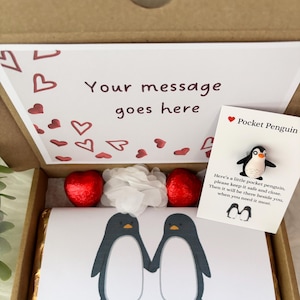 May include: A gift box with a printed card that says "Your message goes here" and a card that says "Pocket Penguin". The box contains a chocolate bar with two penguin illustrations and the text "You are my penguin".