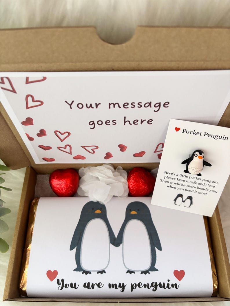 May include: A gift box with a printed card that says "Your message goes here" and a card that says "Pocket Penguin". The box contains a chocolate bar with two penguin illustrations and the text "You are my penguin".