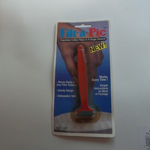 May include: A red and white plastic tool called "Filt-a-Pic" that separates coffee filters in a single second. The packaging says "New!" and "Works Every Time!" with simple instructions on the back of the package. Made in the USA.