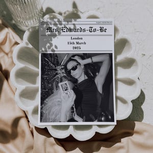 May include: Black and white invitation card with the headline "Mrs. Edwards-To-Be" and the details "London, 15th March 2025". The card features a photo of a person wearing sunglasses and holding a camera.