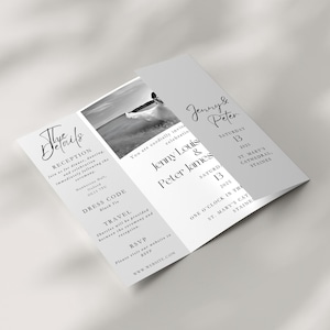 A gatefold wedding invitation on a neutral background