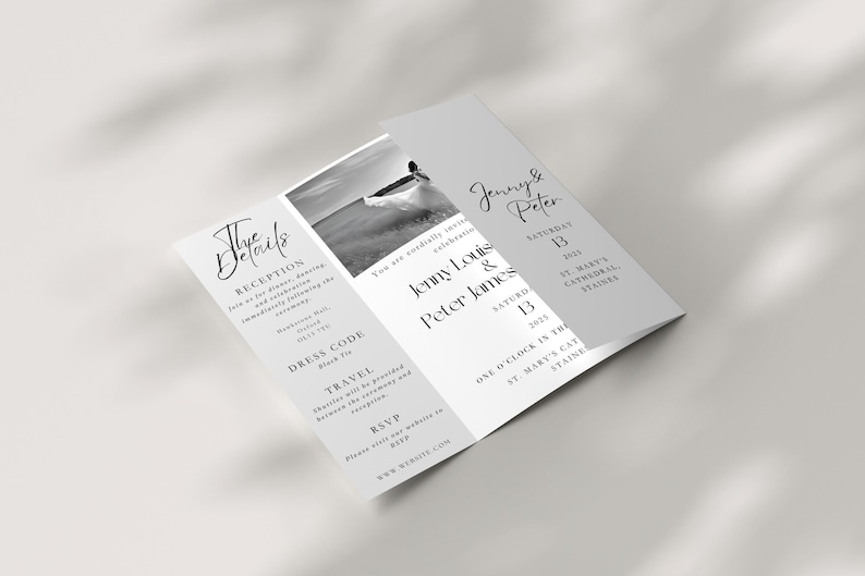 A gatefold wedding invitation on a neutral background