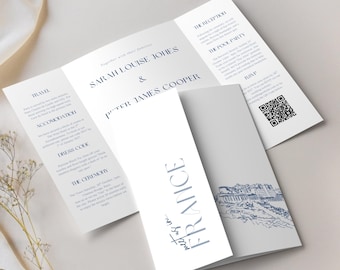 May include: A white wedding invitation with navy blue text, featuring the names Sarah Louise Jones and Peter James Cooper. The invitation includes details about travel, accommodation, dress code, and ceremony information. The word "FRANCE" is displayed vertically.