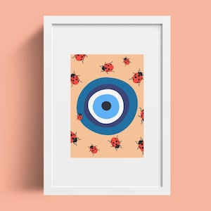 May include: A framed print featuring a blue and white evil eye design surrounded by red ladybirds on a light orange background.