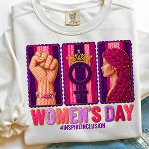 May include: White sweatshirt with a graphic celebrating Women's Day. The design includes a raised fist, a female symbol with a crown, and a woman's profile, all framed in purple. The text "WOMEN'S DAY" and "#INSPIREINCLUSION" are also featured.