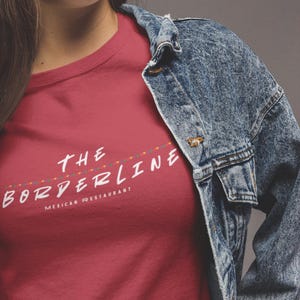 May include: A red t-shirt with the text "THE BORDERLINE MEXICAN RESTAURANT" printed on the front.