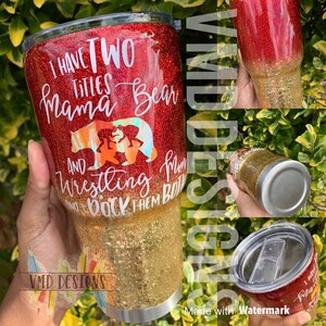 May include: A red and gold glitter tumbler with the text "I have two titles Mama Bear and Wrestling I rock them both". The tumbler features a bear and cubs graphic.